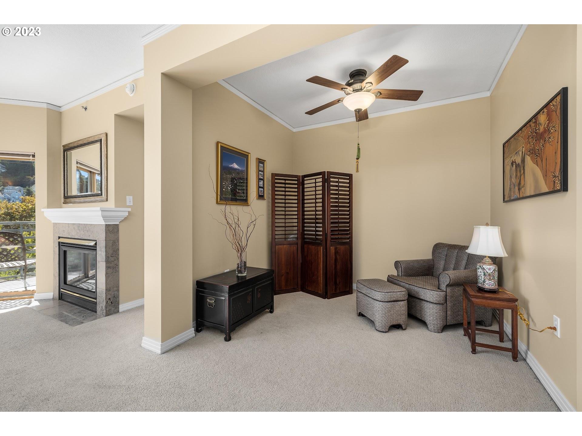 1132 Southwest 19th Avenue, Unit 406 Portland, OR 97205 - Photo 13 of 38 a living room with furniture and a ceiling fan