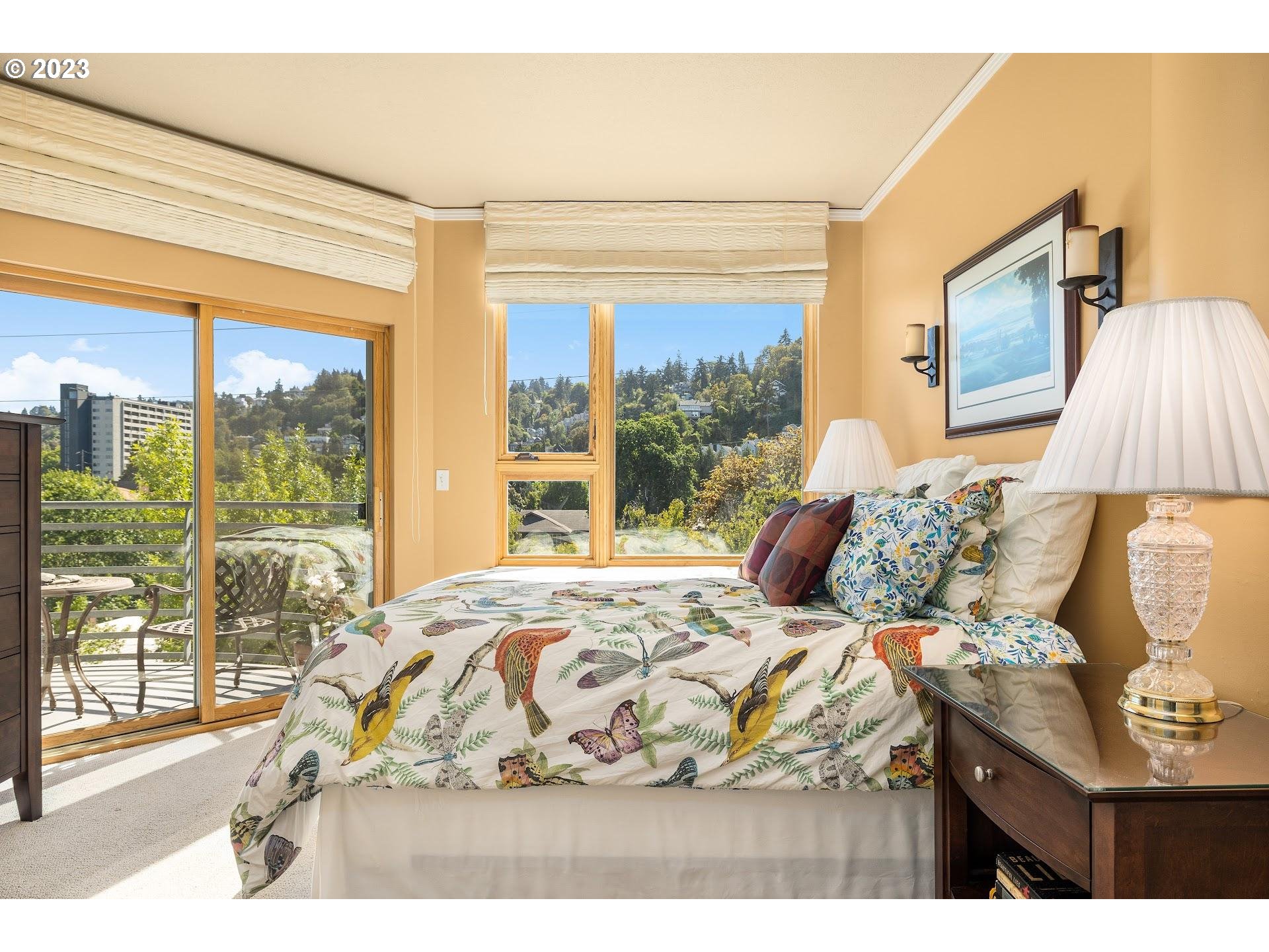 1132 Southwest 19th Avenue, Unit 406 Portland, OR 97205 - Photo 19 of 38 a bedroom with a bed and wooden floor