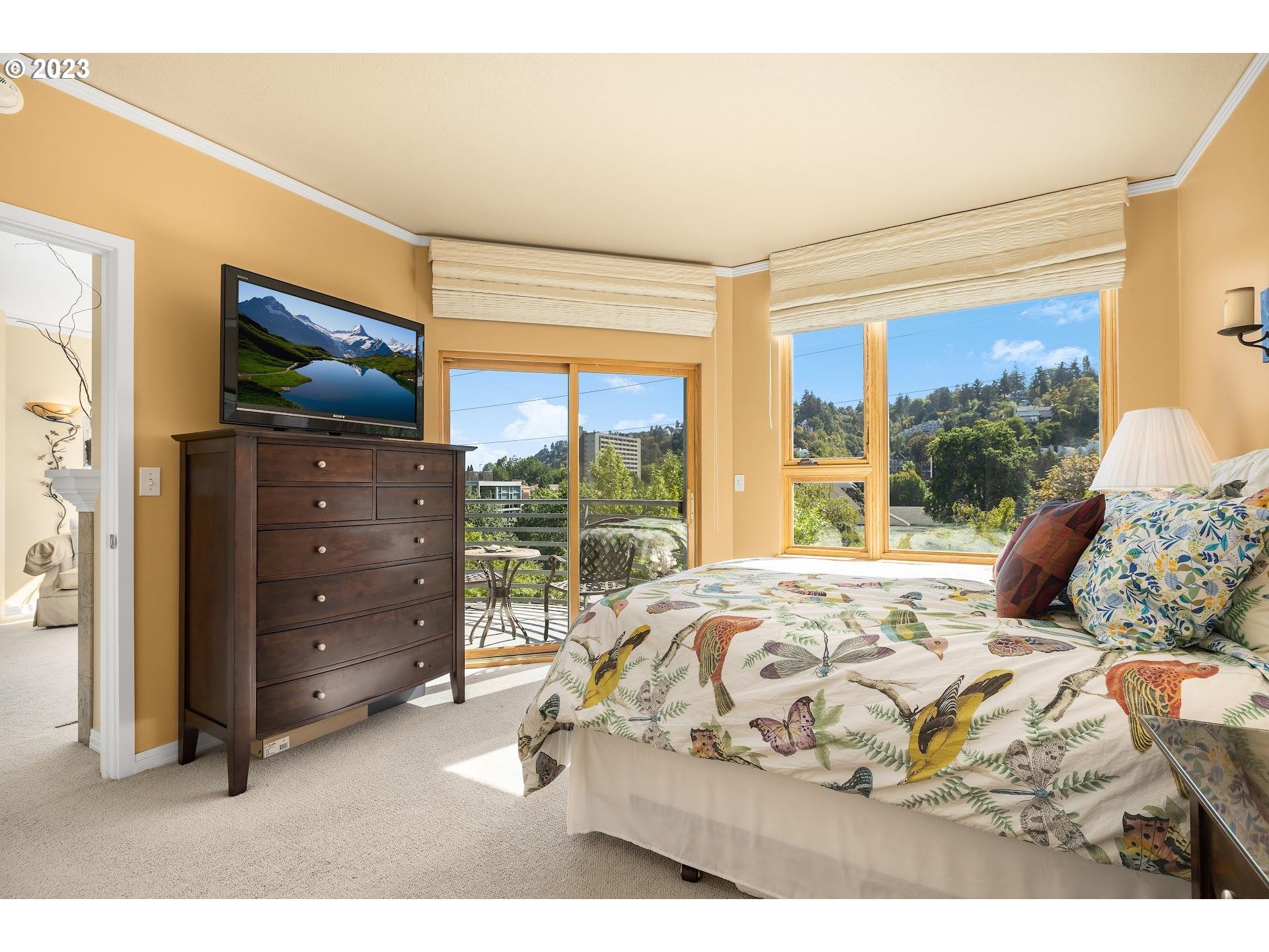 1132 Southwest 19th Avenue, Unit 406 Portland, OR 97205 - Photo 20 of 38 a bedroom with a bed and a large window