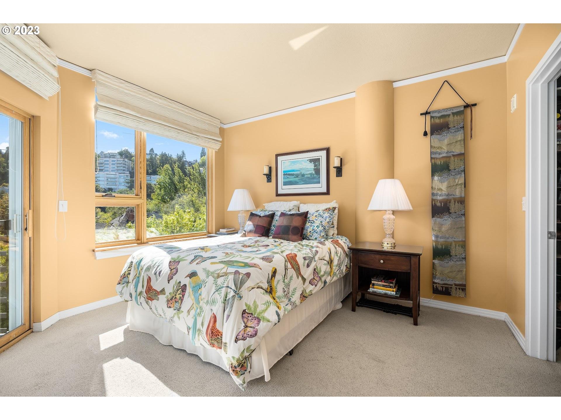 1132 Southwest 19th Avenue, Unit 406 Portland, OR 97205 - Photo 21 of 38 a bedroom with a bed and wooden floor