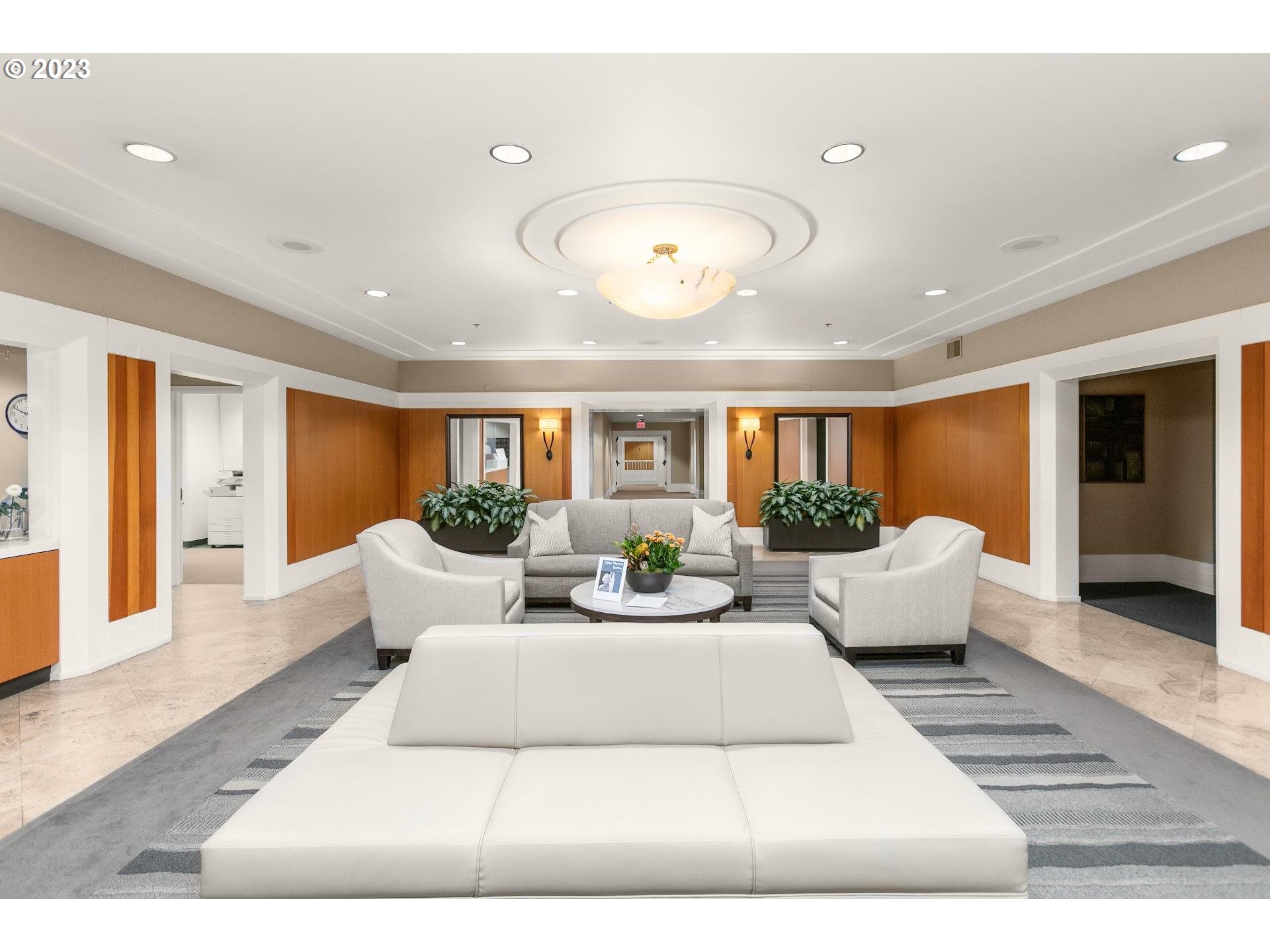 1132 Southwest 19th Avenue, Unit 406 Portland, OR 97205 - Photo 30 of 38 a living room with furniture potted plant and a large window