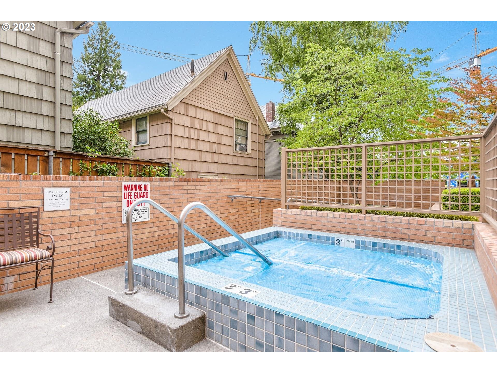 1132 Southwest 19th Avenue, Unit 406 Portland, OR 97205 - Photo 34 of 38 a backyard of a house with table and chairs