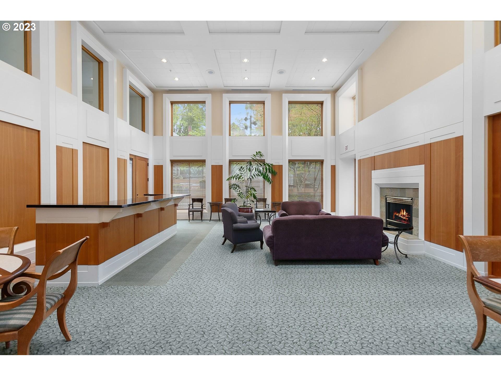 1132 Southwest 19th Avenue, Unit 406 Portland, OR 97205 - Photo 36 of 38 a living room with furniture and a fireplace