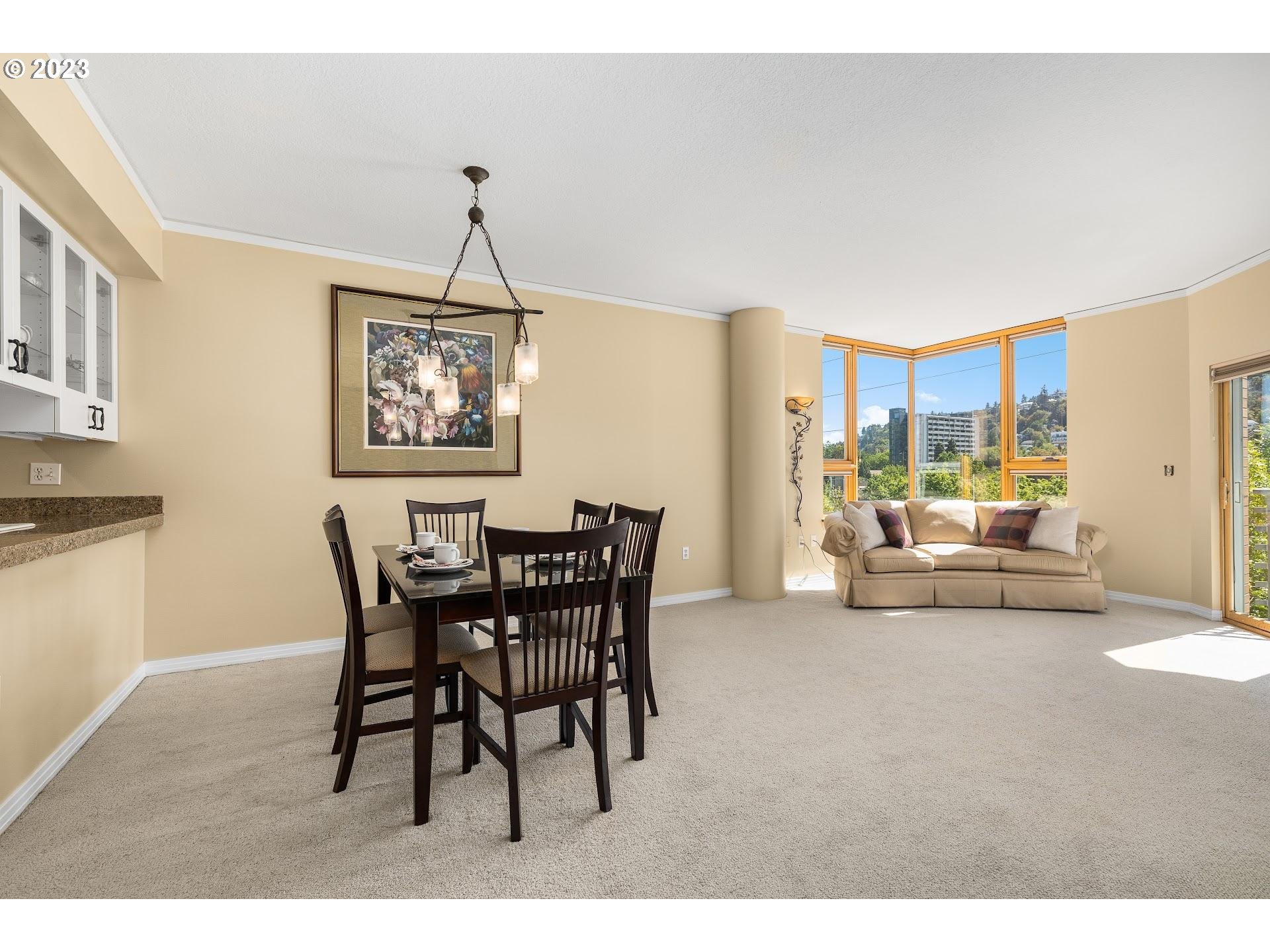1132 Southwest 19th Avenue, Unit 406 Portland, OR 97205 - Photo 6 of 38 a dining room with furniture and window