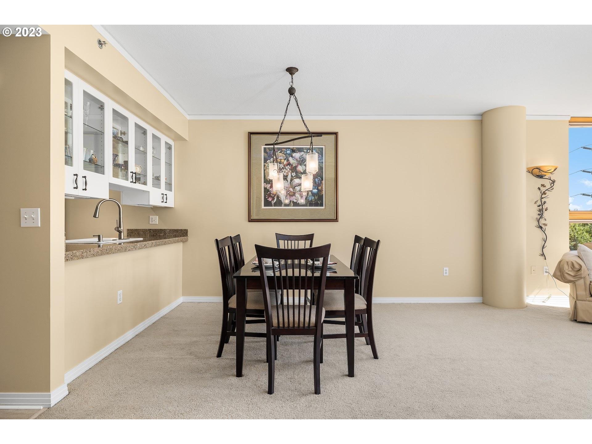1132 Southwest 19th Avenue, Unit 406 Portland, OR 97205 - Photo 7 of 38 a dining room with furniture and window