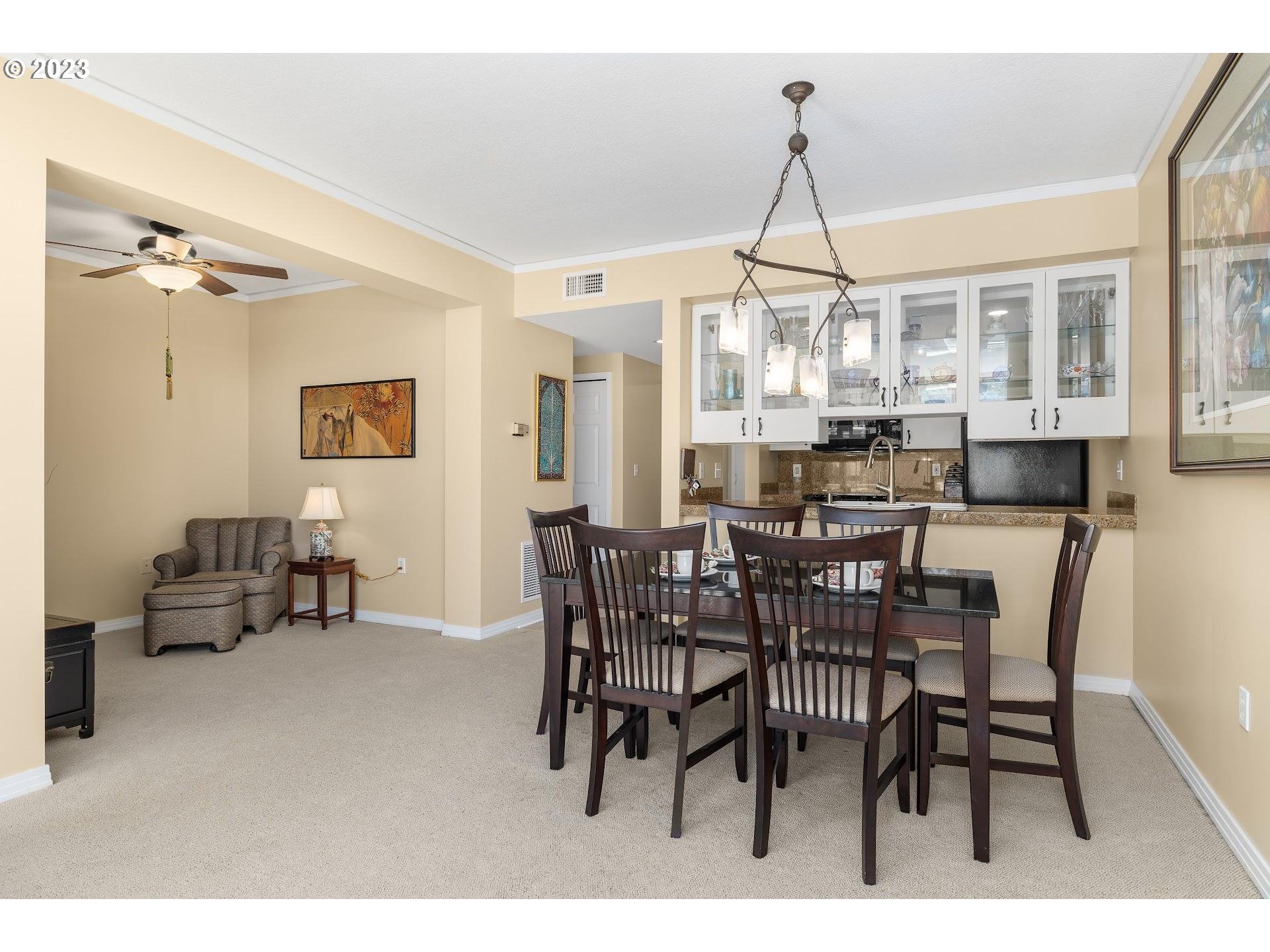 1132 Southwest 19th Avenue, Unit 406 Portland, OR 97205 - Photo 8 of 38 a dining room with furniture a chandelier and window