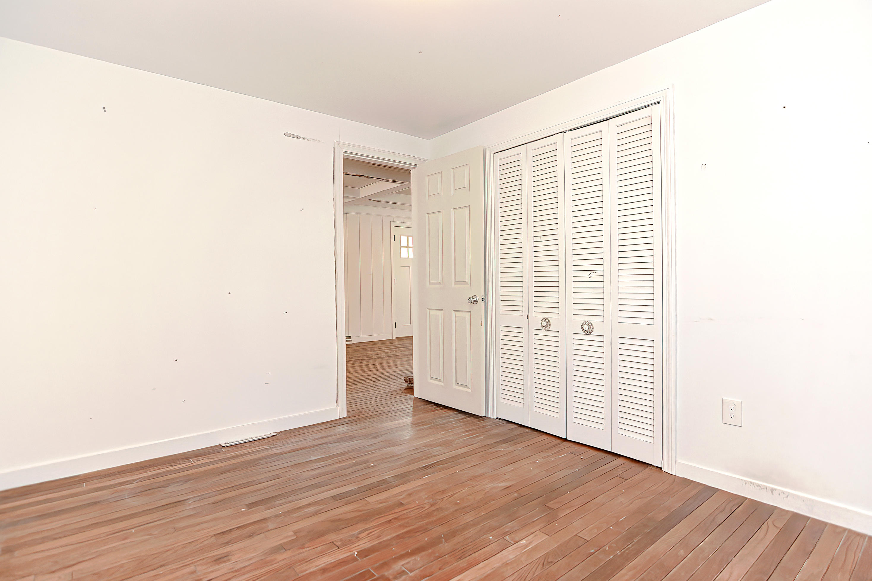 321 Monomoscoy Road Mashpee, MA 02649 - Photo 17 of 43 an empty room with wooden floor