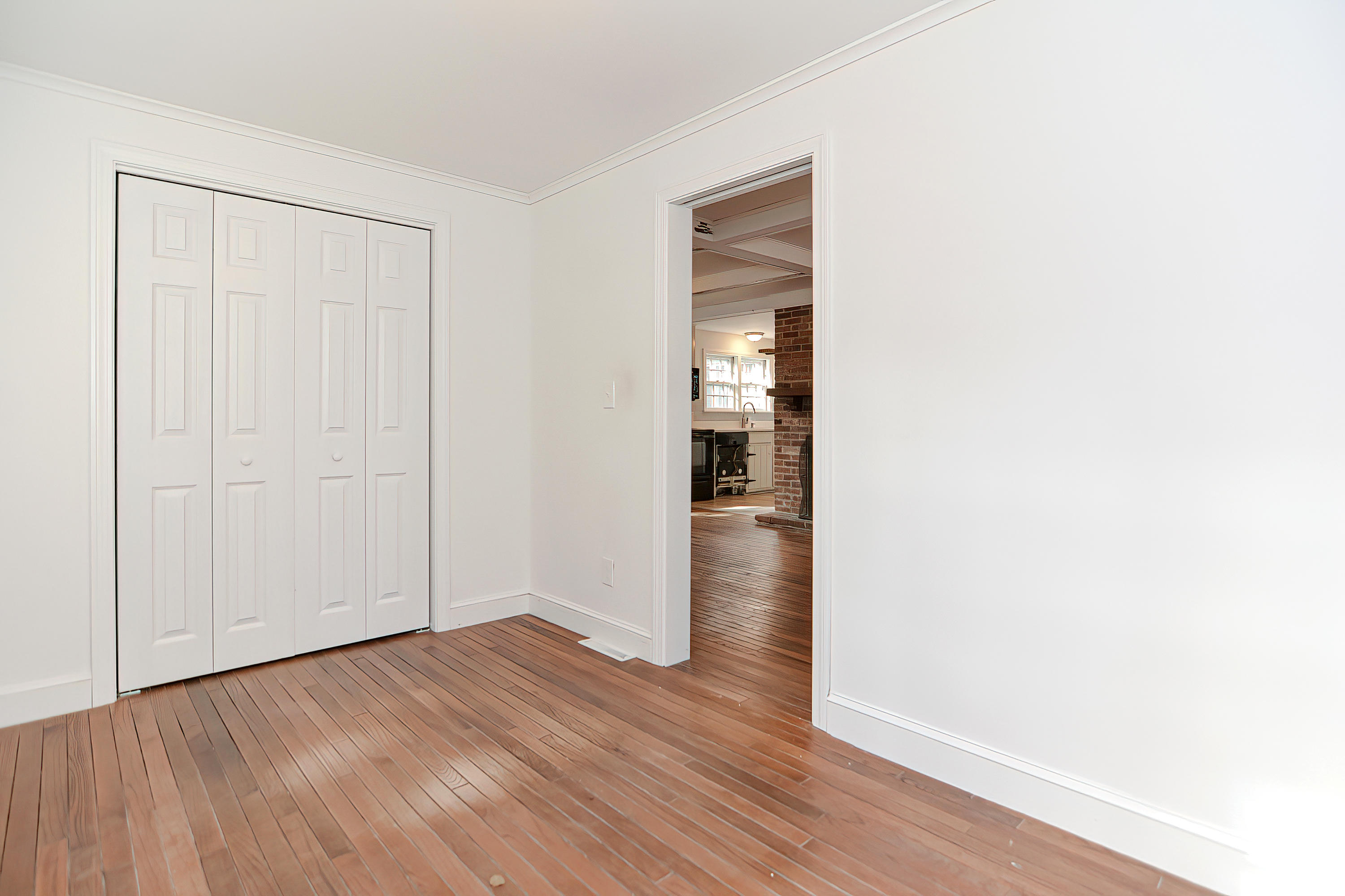 321 Monomoscoy Road Mashpee, MA 02649 - Photo 21 of 43 a view of an empty room with wooden floor and closet