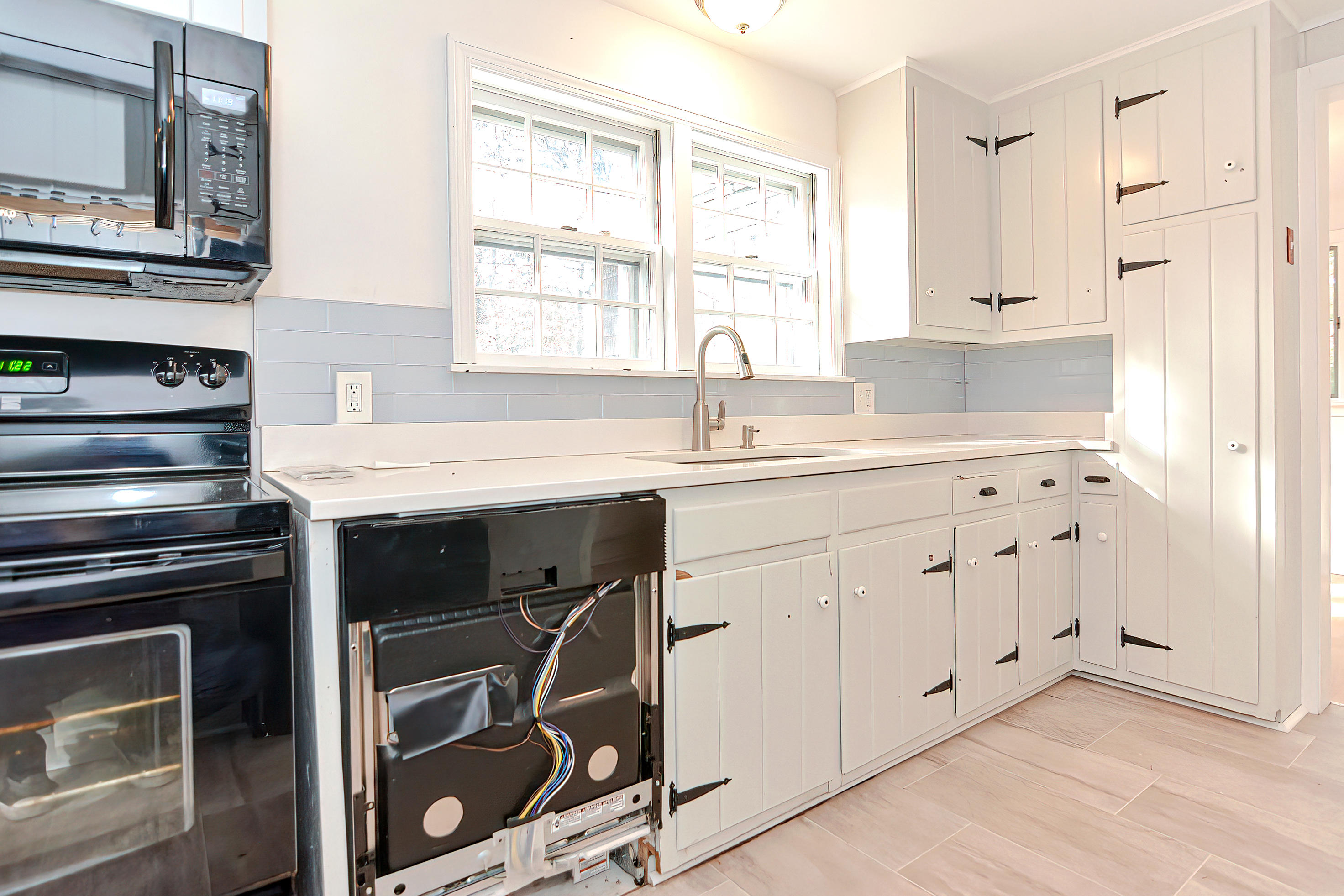 321 Monomoscoy Road Mashpee, MA 02649 - Photo 26 of 43 a kitchen with stainless steel appliances a stove sink and cabinets