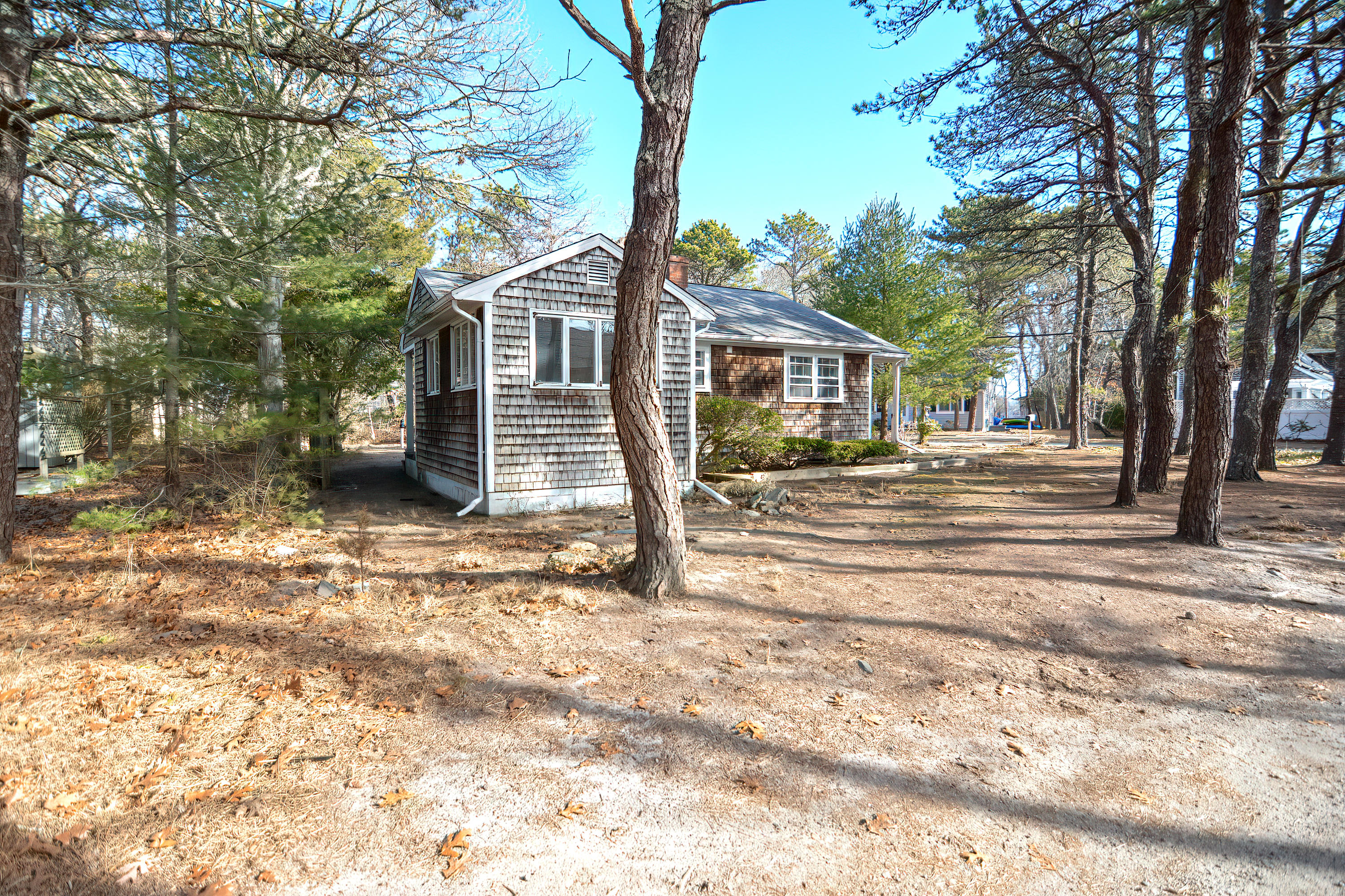 321 Monomoscoy Road Mashpee, MA 02649 - Photo 3 of 43 a front view of a house with a yard