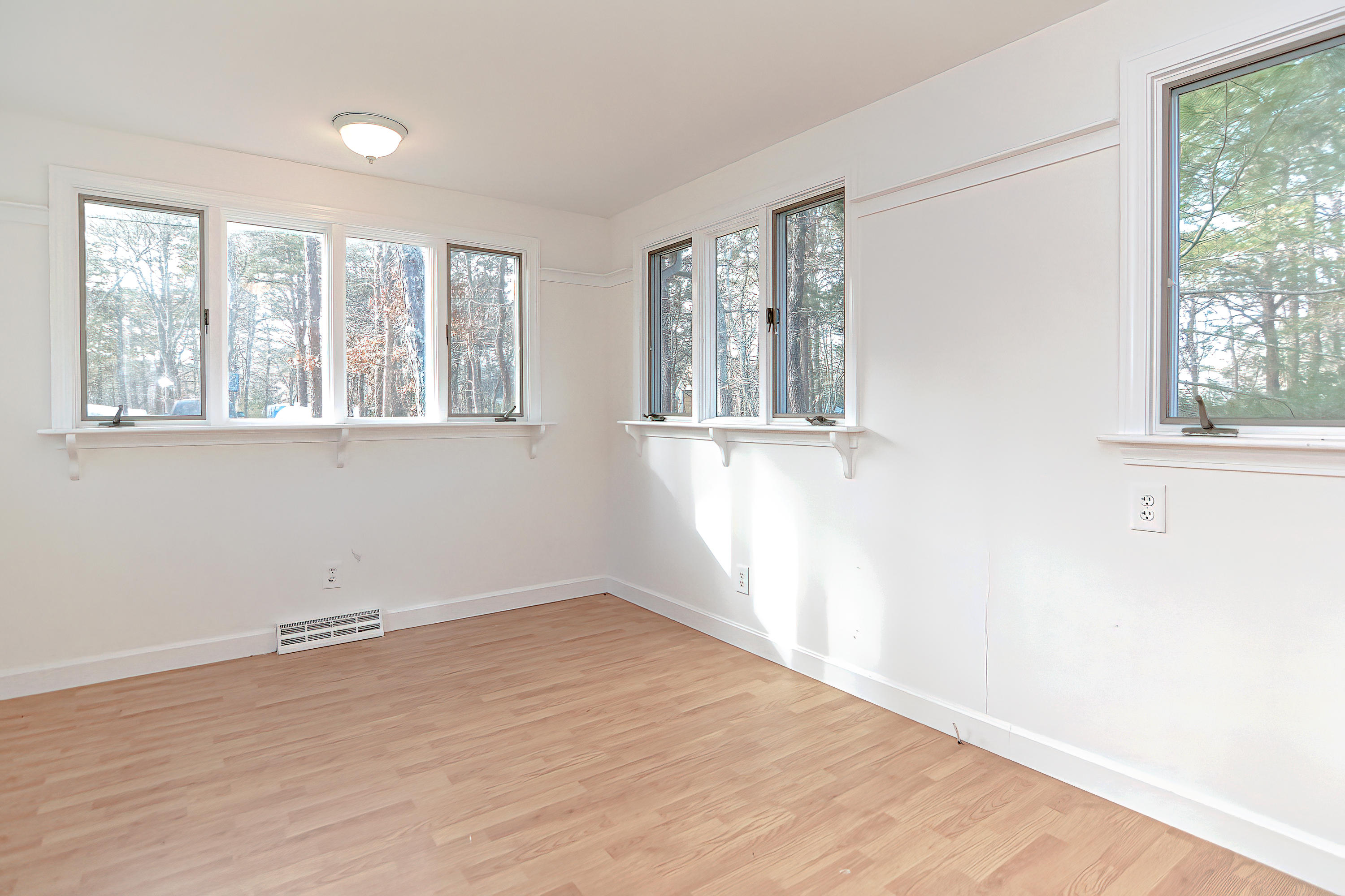 321 Monomoscoy Road Mashpee, MA 02649 - Photo 34 of 43 an empty room with wooden floor and windows