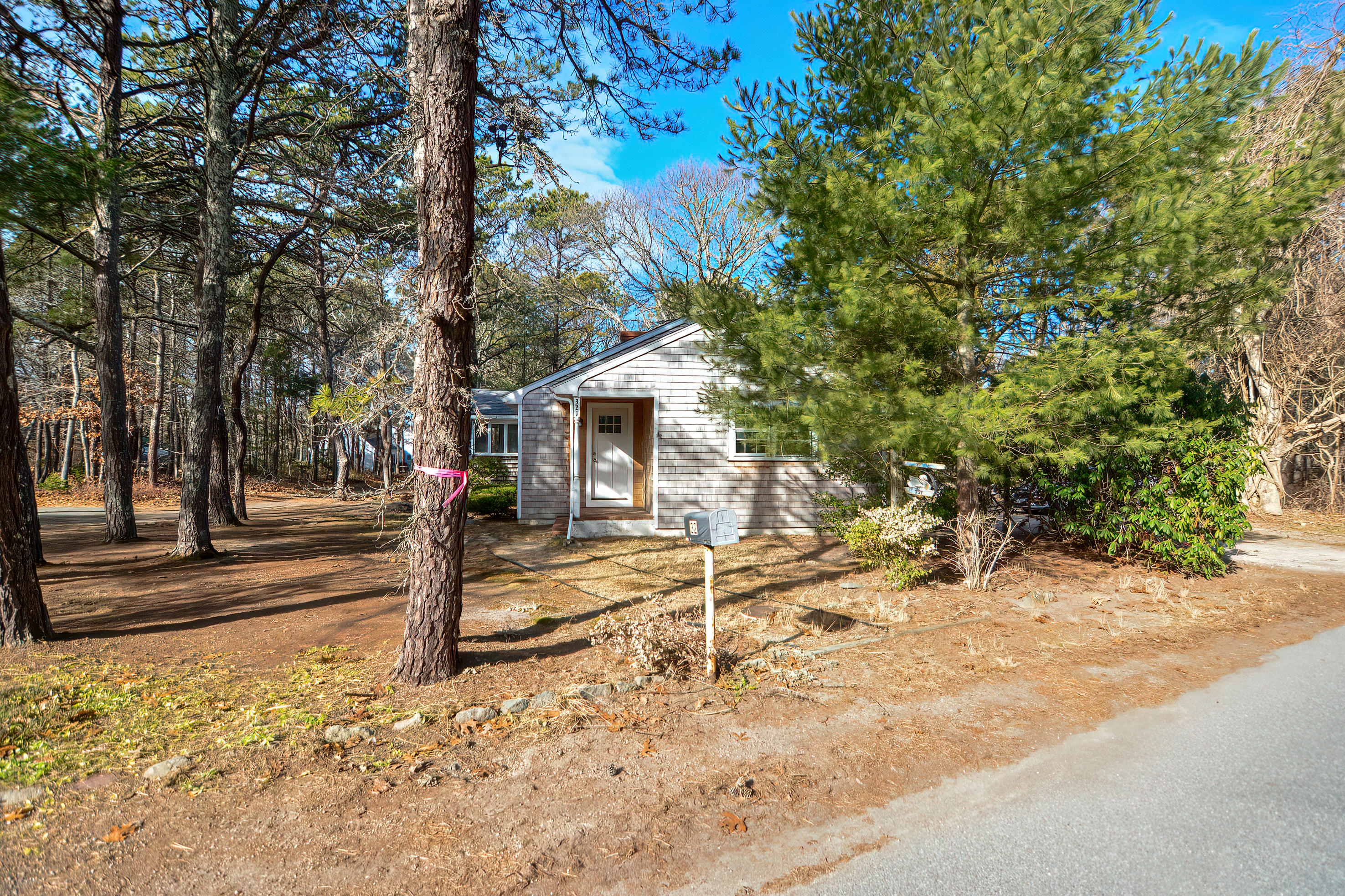 321 Monomoscoy Road Mashpee, MA 02649 - Photo 5 of 43 a view of a house with a snow on the road