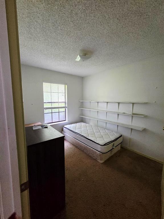 722 South Church Street Pilot Point, TX 76258 - Photo 17 of 37 a bedroom with a bed and a window