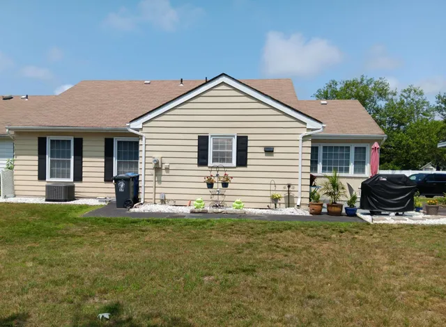 a front view of house with yard outdoor seating and barbeque oven