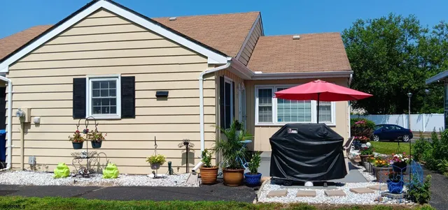 a front view of house with yard and outdoor seating