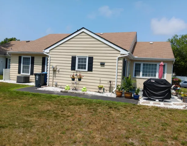 a view of a house with backyard and sitting area
