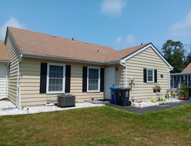 a front view of a house with a garden and patio