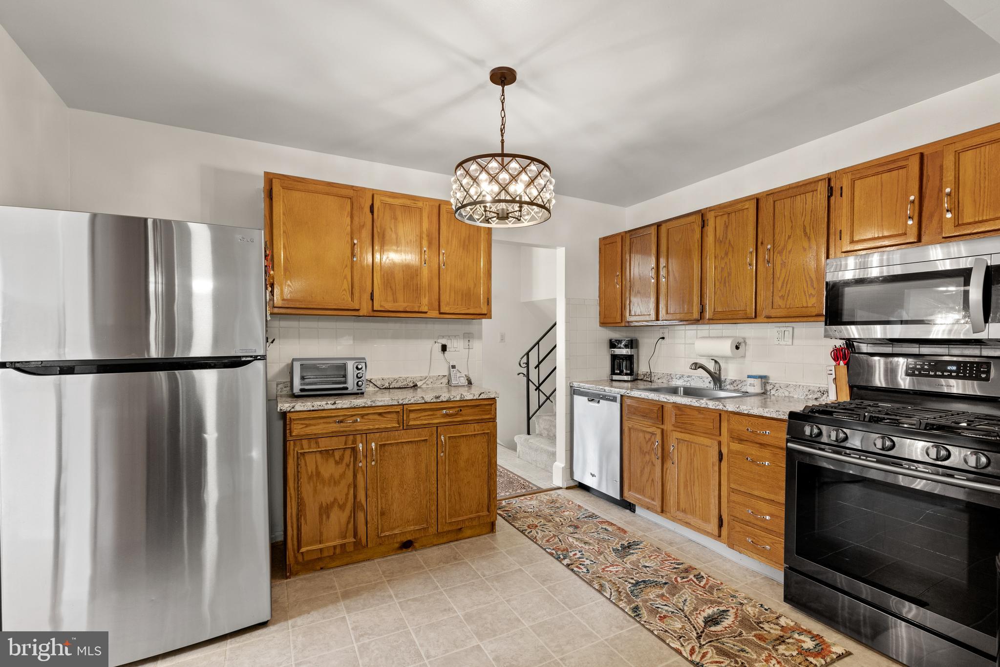 12401 Barbara Road Silver Spring, MD 20906 - Photo 7 of 17 a kitchen with granite countertop a refrigerator stove top oven a sink and dishwasher