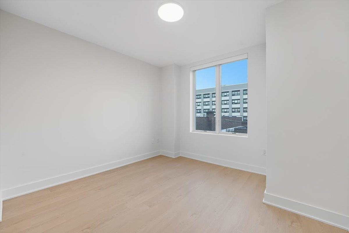 303 Madison Street, Unit 408 Hoboken, NJ 07030 - Photo 4 of 26 a view of an empty room with a window