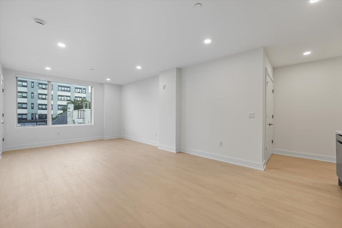 303 Madison Street, Unit 408 Hoboken, NJ 07030 - Photo 8 of 26 an empty room with windows