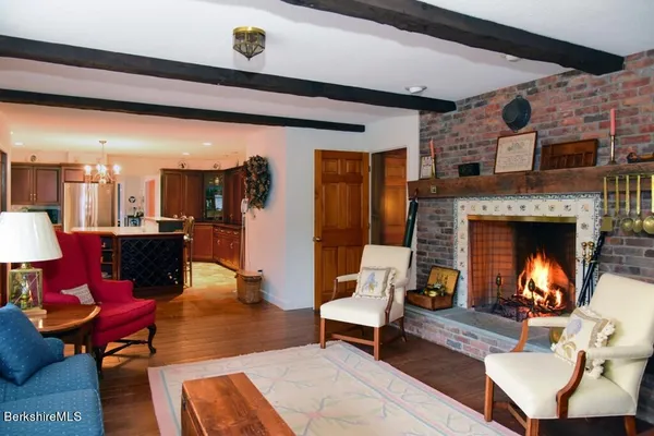 a kitchen with stainless steel appliances granite countertop wooden cabinets a stove a sink and a refrigerator