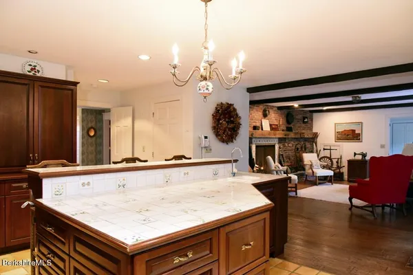 a living room with furniture pool table and a fireplace