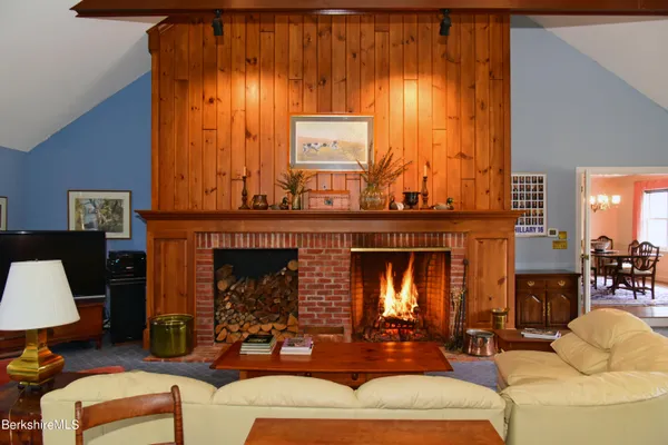 a living room with furniture and a dining table