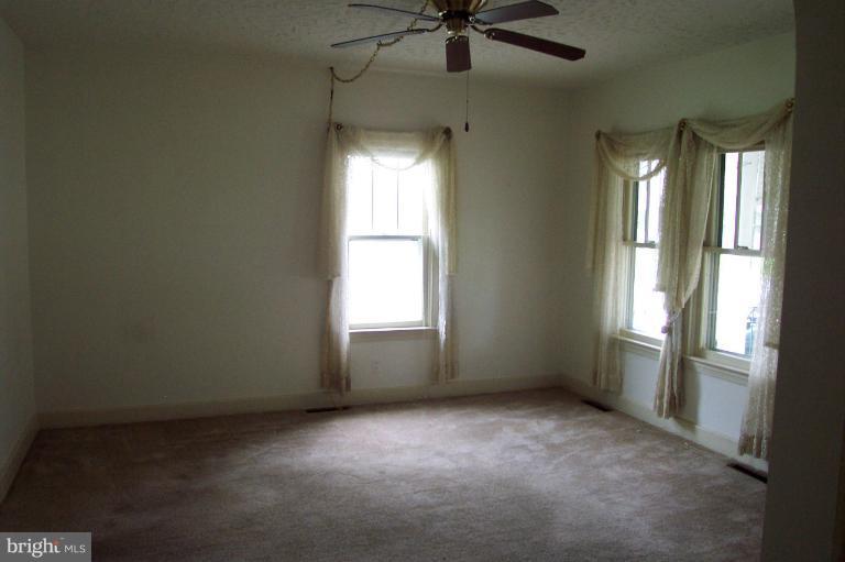 103 Rambler Road Cambridge, MD 21613 - Photo 14 of 19 Living room has ceiling fan and carpet