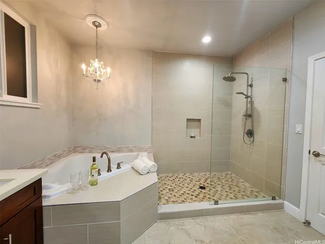 a spacious bedroom with a bed and a chandelier