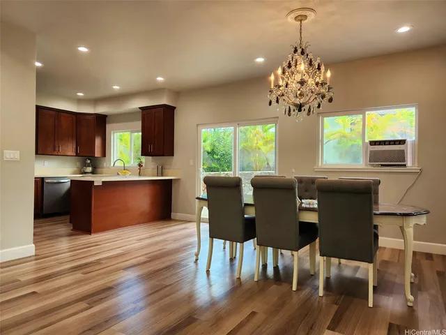 a kitchen with stainless steel appliances granite countertop wooden cabinets a stove and a sink