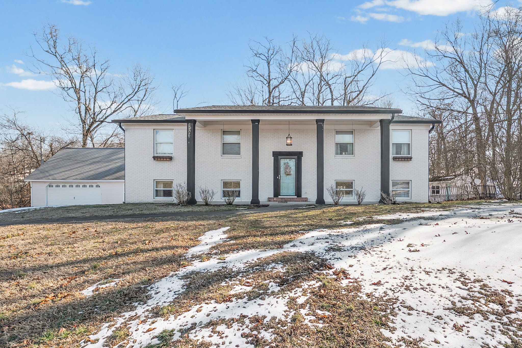 a view of a house with a snow on the road