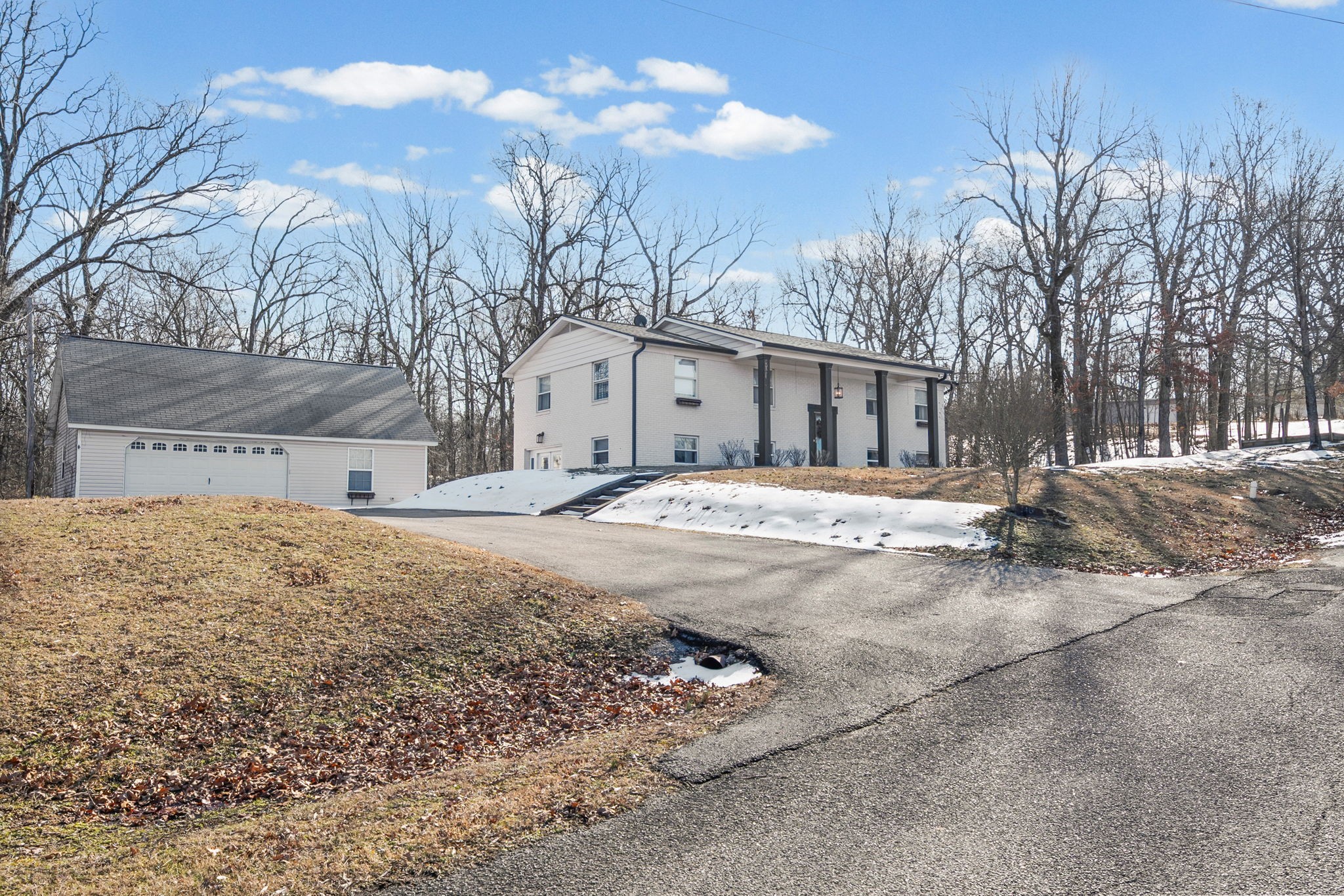 148 Green Hill Drive Grand Rivers, KY 42045 - Photo 2 of 65 a view of the house with snow on the road