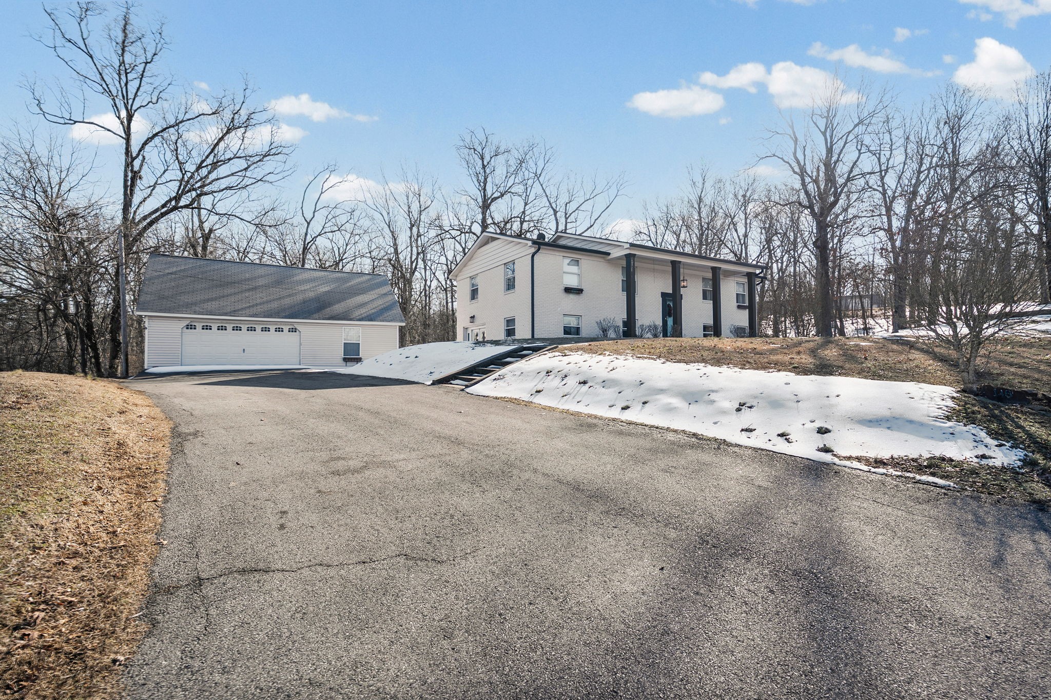 148 Green Hill Drive Grand Rivers, KY 42045 - Photo 4 of 65 a view of white house with a yard covered in snow