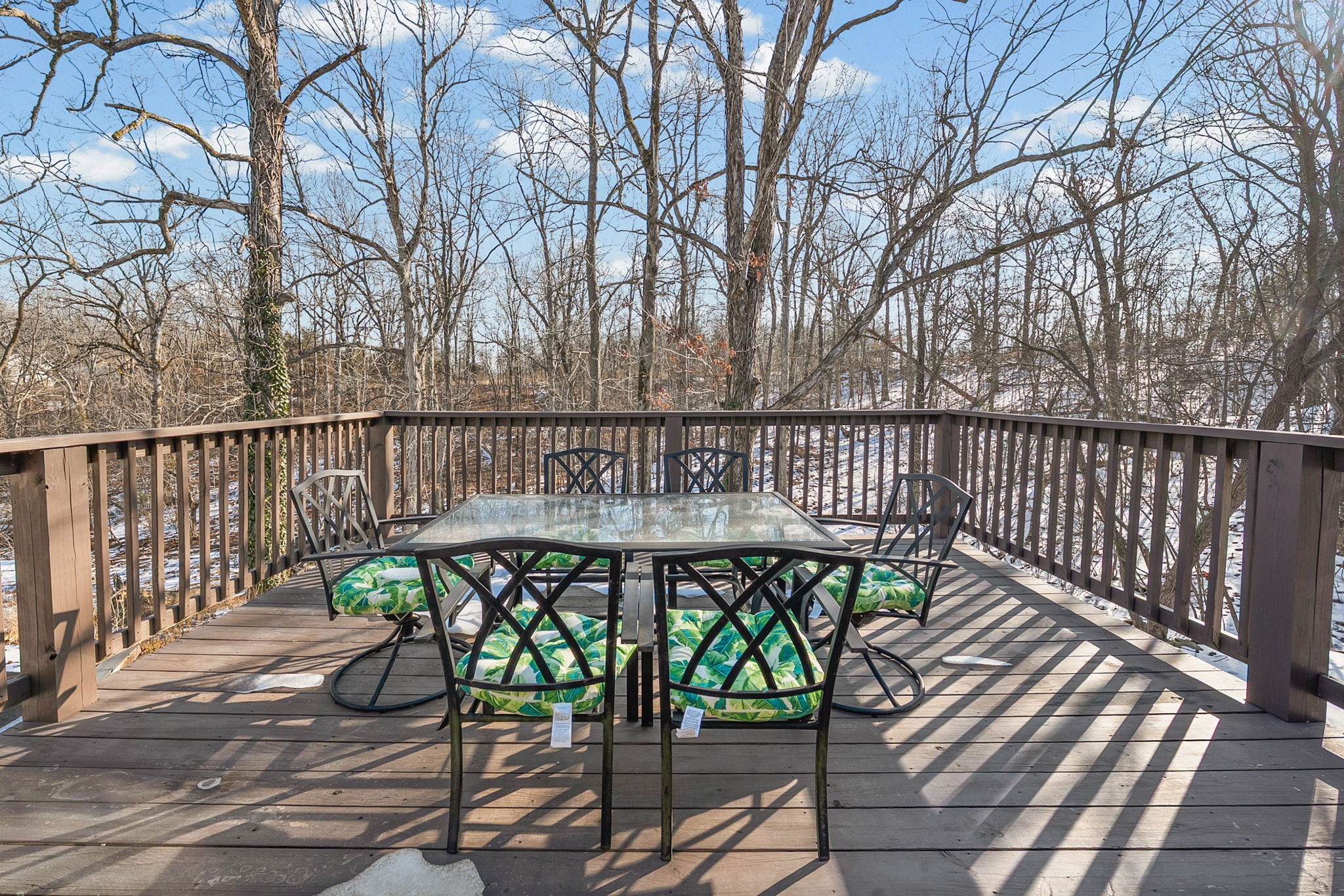 148 Green Hill Drive Grand Rivers, KY 42045 - Photo 48 of 65 a view of a patio with a table and chairs with wooden floor and fence