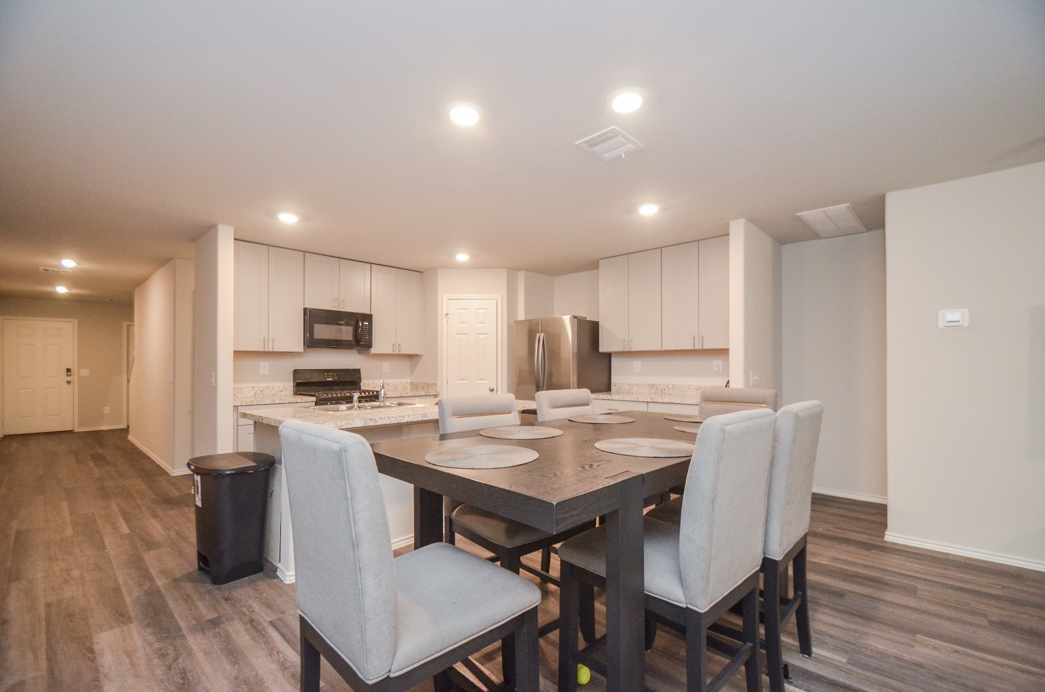 a view of kitchen with cabinets table and chairs