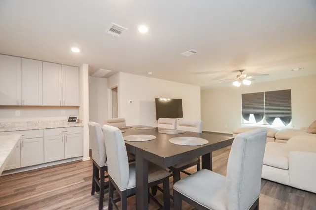 a view of a dining room with furniture and wooden floor