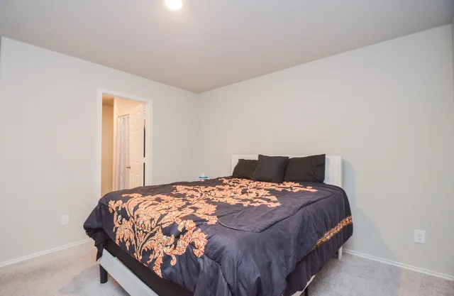 a bedroom with a bed and window