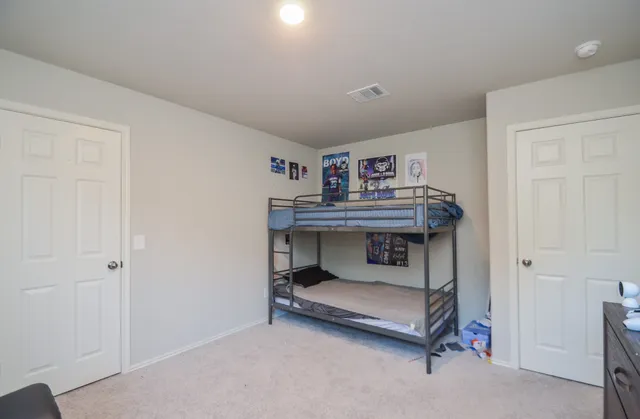 a bathroom with a granite countertop sink a toilet and a mirror