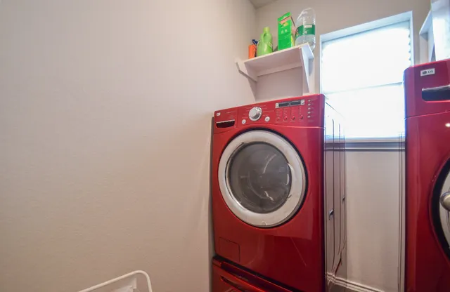 a back yard of the house with a yard