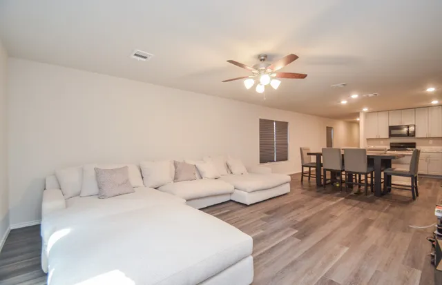 a living room with furniture and kitchen view