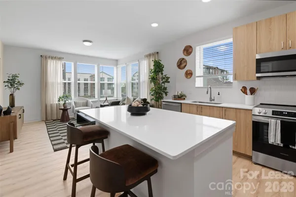 a kitchen with a table chairs stove and microwave