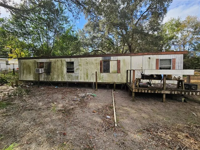 a backyard of a house with barbeque oven and outdoor seating