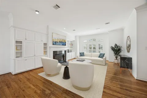 a view of empty room with wooden floor and fireplace