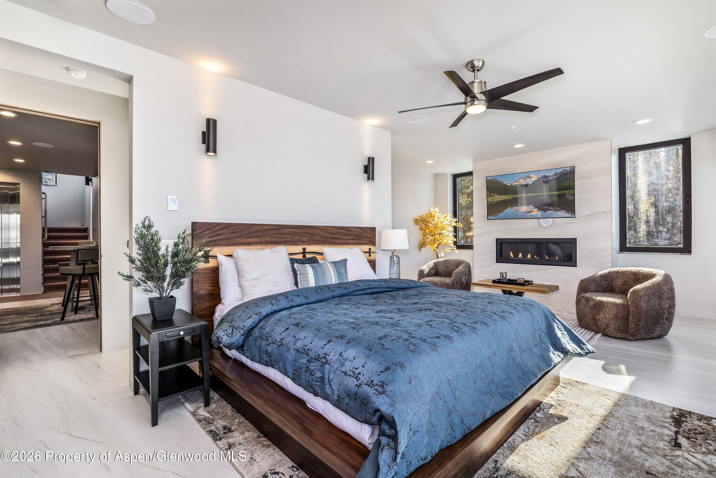 316 Fuller Placer Road Breckenridge, CO 80424 - Photo 27 of 52 a bedroom with a bed a window and a chandelier