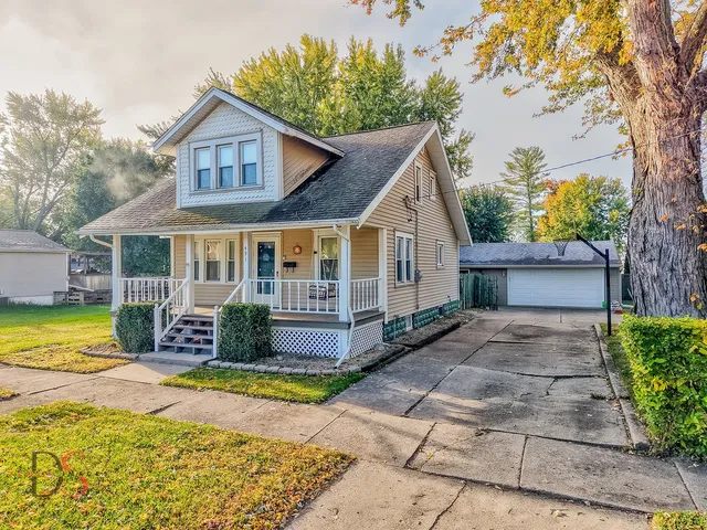 a front view of a house with swimming pool having outdoor seating