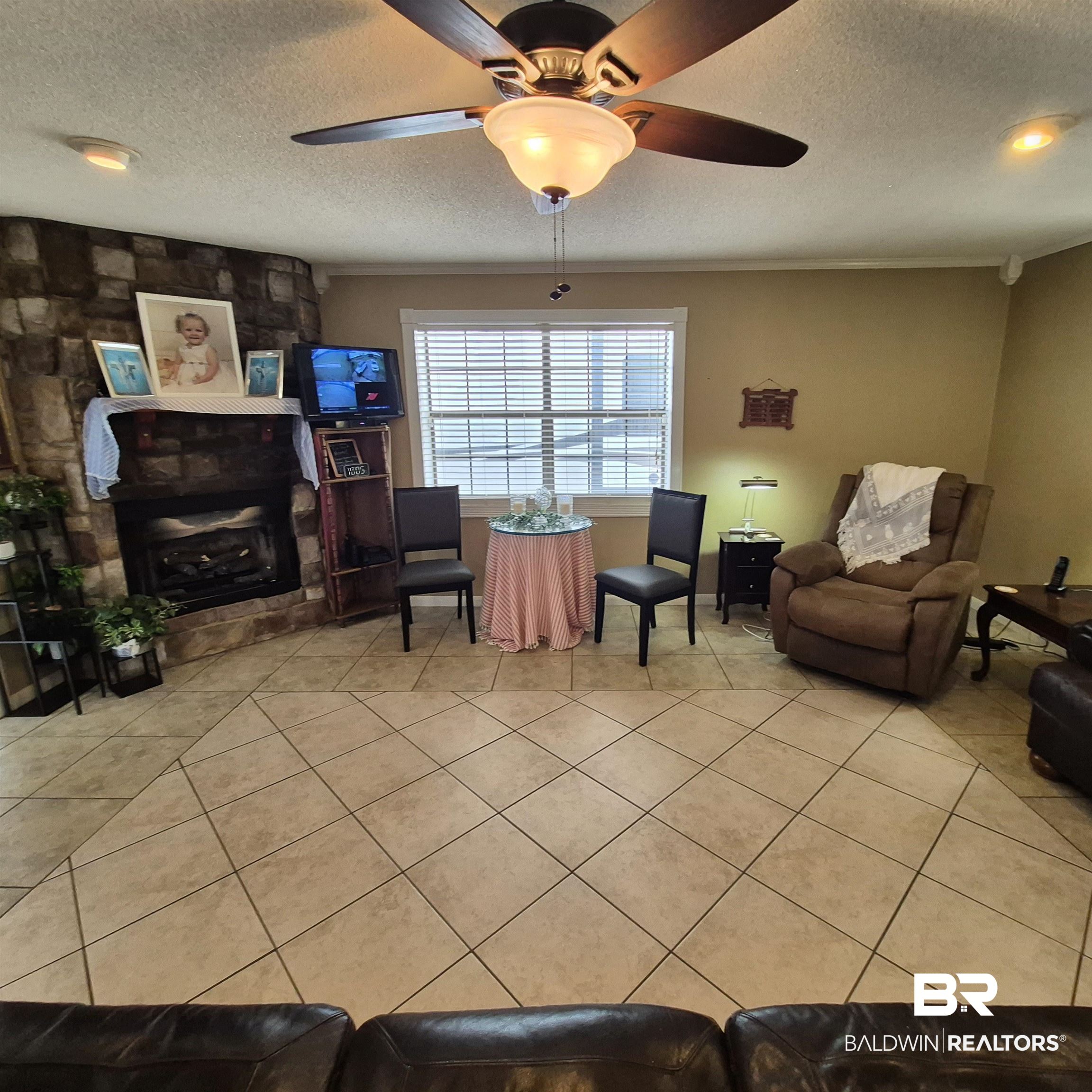 26635 Highway 41 Range, AL 36473 - Photo 8 of 74 Sitting room with a textured ceiling, a ceiling fan, and light tile patterned flooring