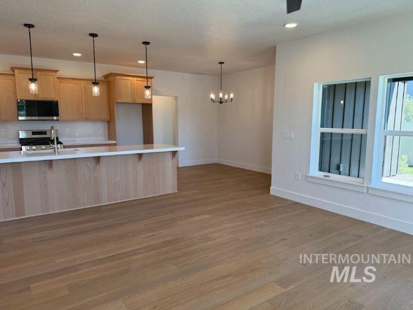 755 West Wrangler Street Meridian, ID 83646 - Photo 4 of 35 Open-concept living area featuring light wood-finish flooring throughout