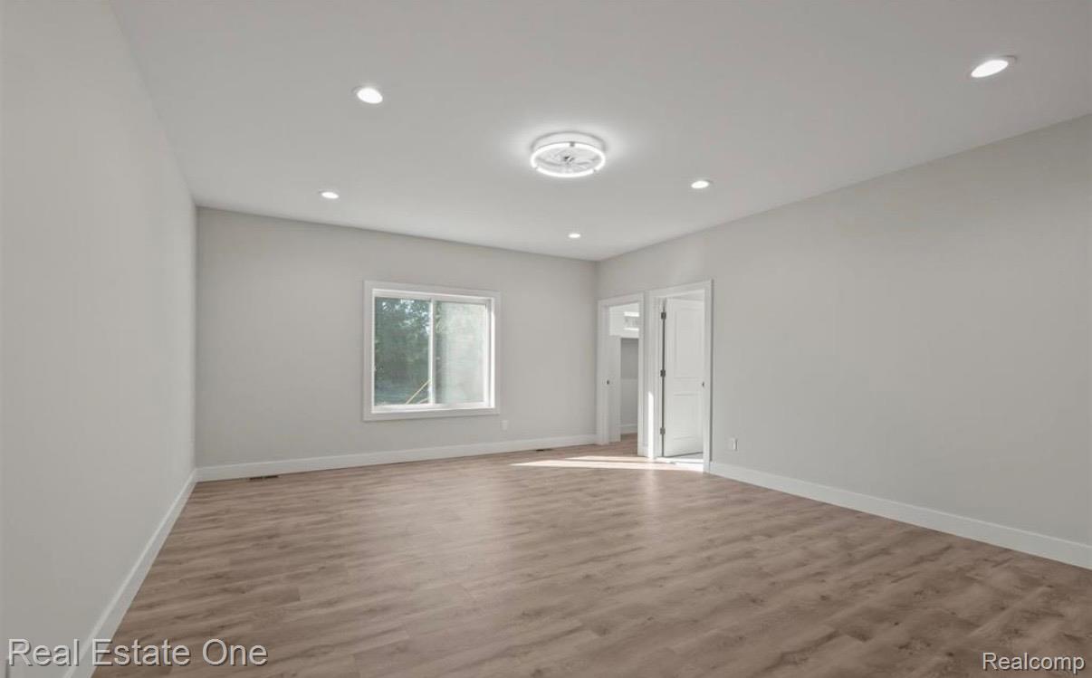 5636 Paris Street Sterling Heights, MI 48310 - Photo 10 of 37 Empty room featuring wood finished floors and recessed lighting