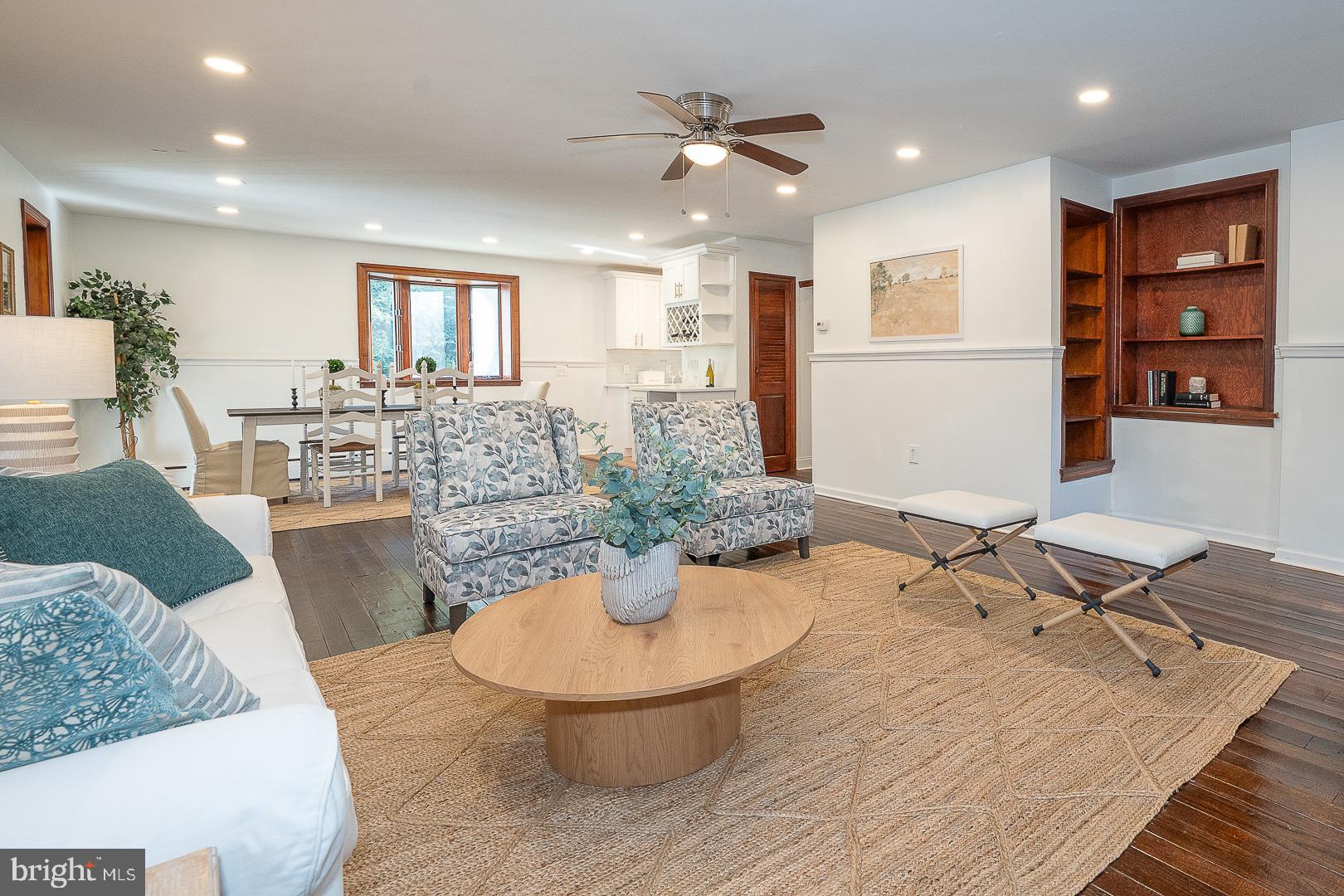 875 Old State Road Berwyn, PA 19312 - Photo 12 of 30 a living room with furniture and a dining table with wooden floor