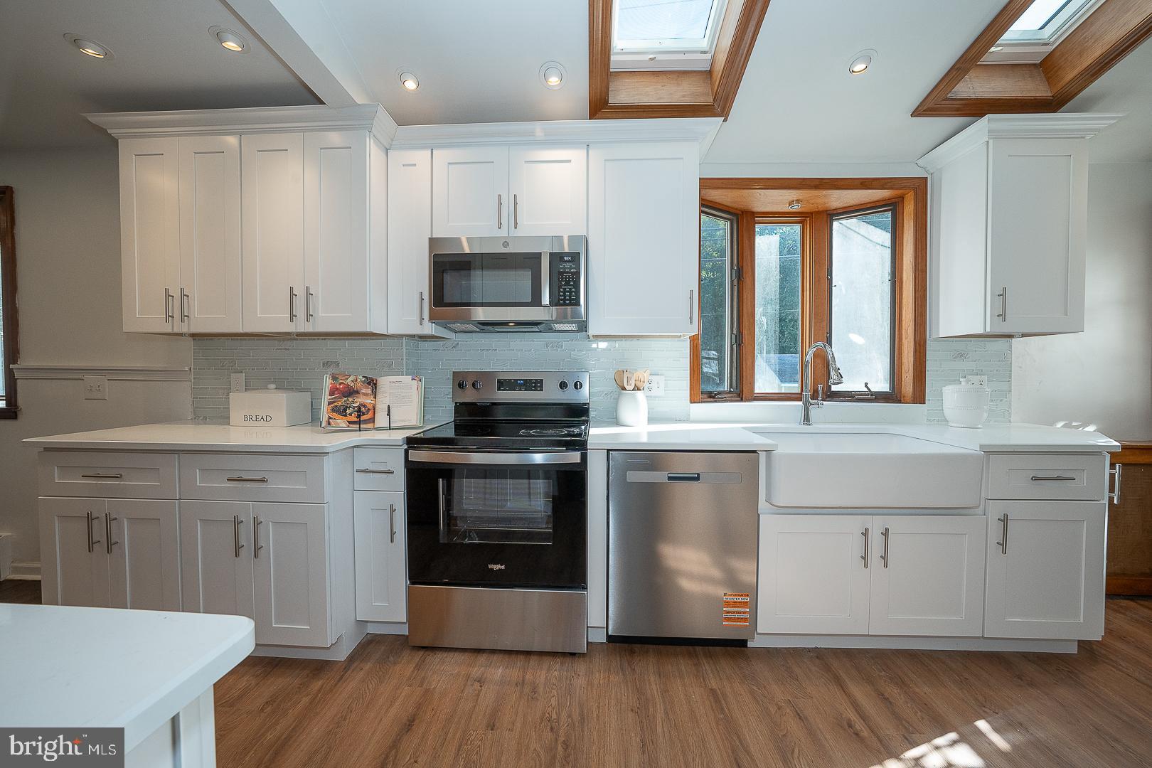 875 Old State Road Berwyn, PA 19312 - Photo 16 of 30 a kitchen with stainless steel appliances granite countertop a stove a sink and a microwave